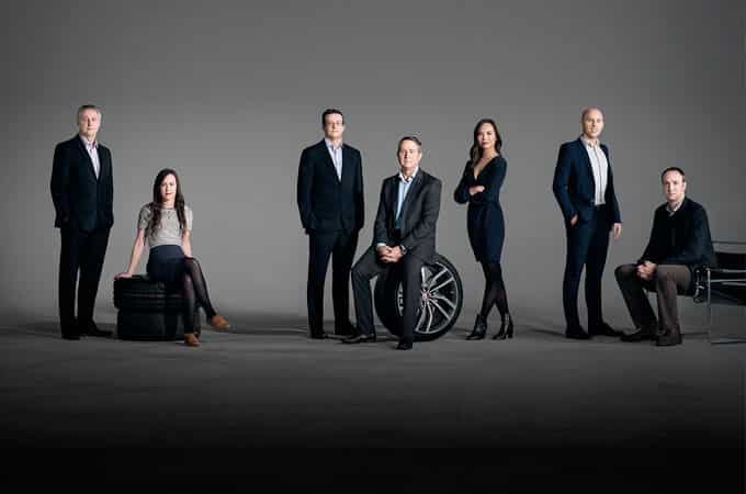 Jaguar experts, dubbed the 'magnificent seven' pose on tyres and chairs.